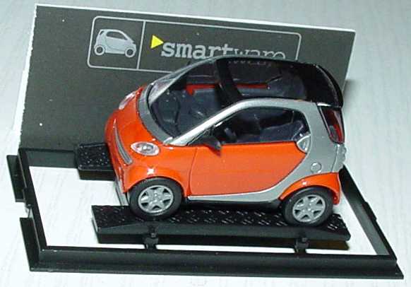 Foto 1:87 MCC Smart City-Coupé dunkelorange/silber Werbemodell Busch 0013097V001000000