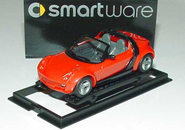 Foto 1:87 MCC Smart Roadster mad-red, Scheinwerfereinfassung in Wagenfarbe Werbemodell Busch 0013097V002000000