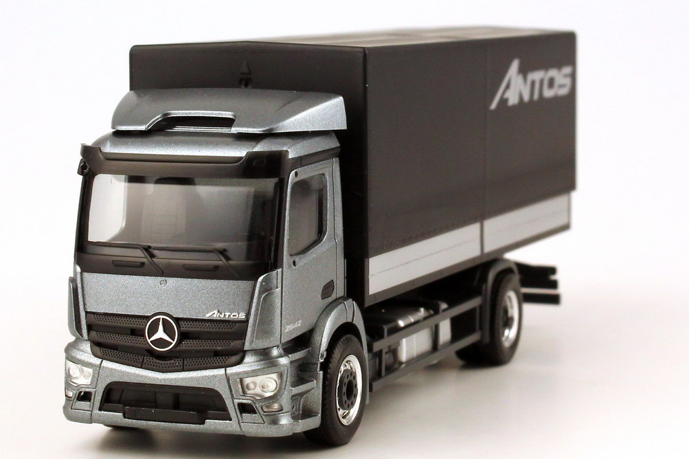 Foto 1:87 Mercedes-Benz Antos Pritsche/Plane andorit-grau-met. Werbemodell - herpa B66004090